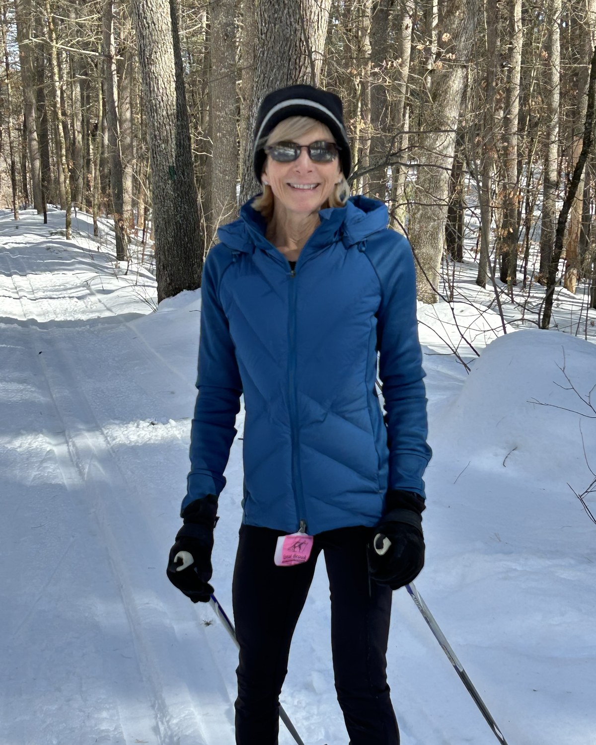 Nina Caron cross-country skiing on a snowy forest trail